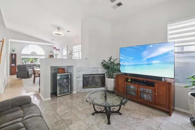 a living room with furniture a fireplace and a flat screen tv