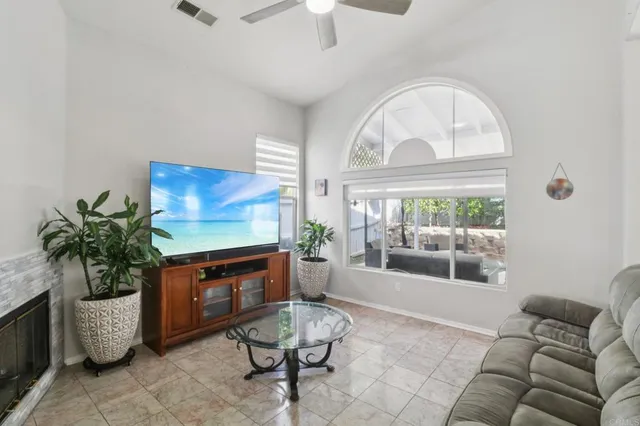 a living room with furniture a fireplace and a chandelier