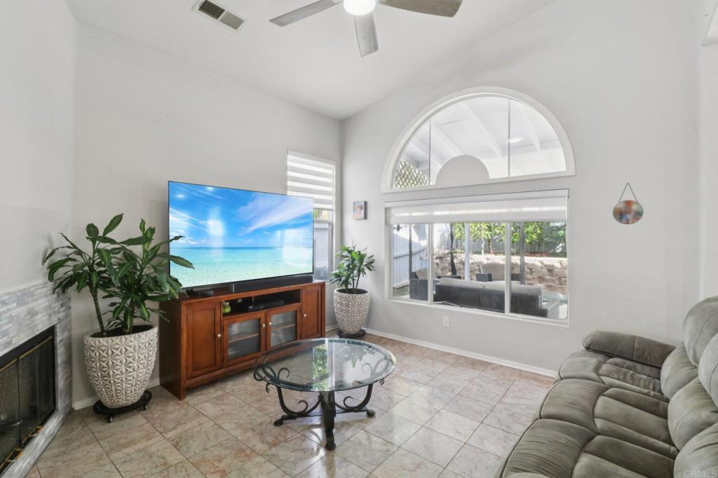 232 Manzanilla Way Oceanside, CA 92057 - Photo 10 of 35 a living room with furniture a fireplace and a chandelier