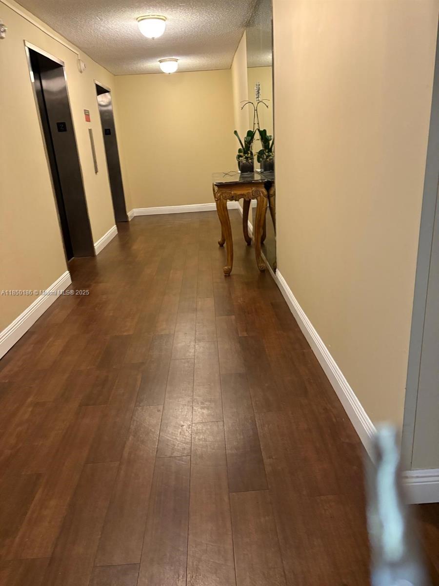 800 Northeast 195th Street, Unit 215 Miami, FL 33179 - Photo 7 of 11 a view of entryway with wooden floor