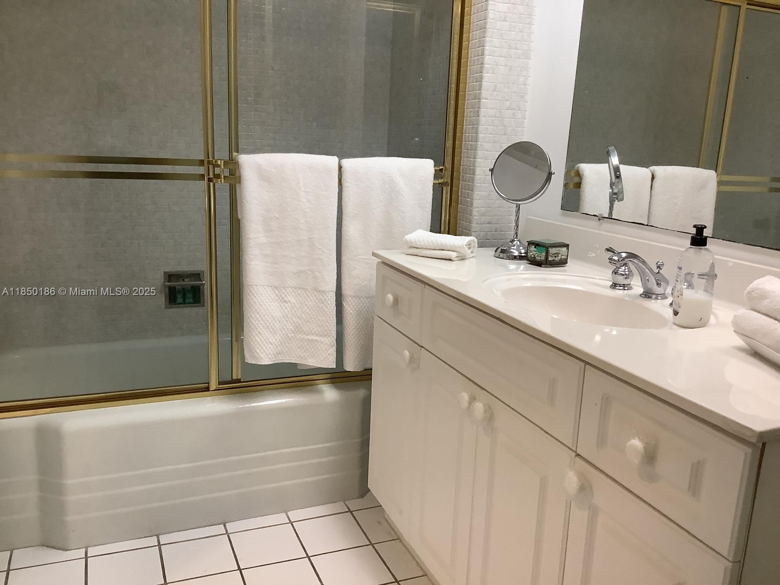 800 Northeast 195th Street, Unit 215 Miami, FL 33179 - Photo 9 of 11 a bathroom with a bathtub and a sink