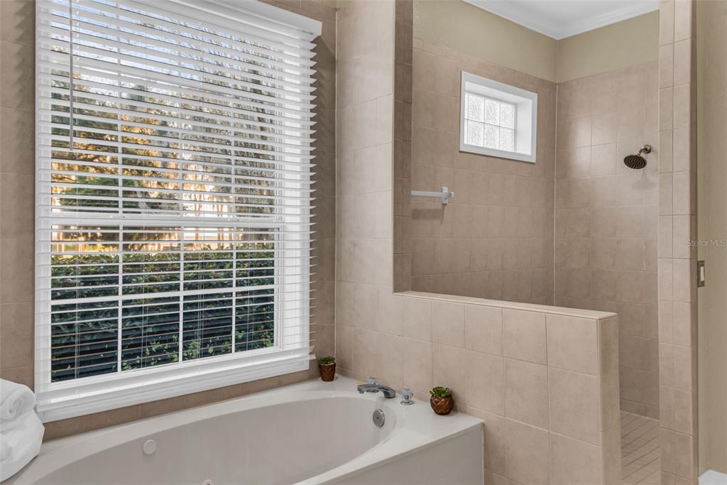 1425 Riviera Drive Kissimmee, FL 34744 - Photo 24 of 82 a bathroom with a bathtub next to a window