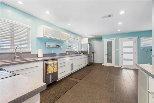 a kitchen with stainless steel appliances granite countertop a stove and a sink
