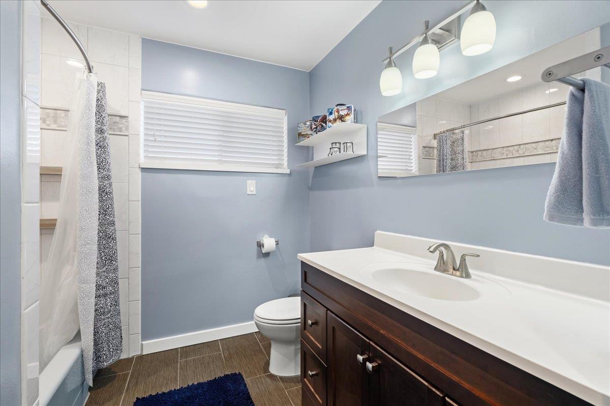 7261 Dry Creek Road Rio Linda, CA 95673 - Photo 17 of 60 a bathroom with a sink a toilet and a mirror