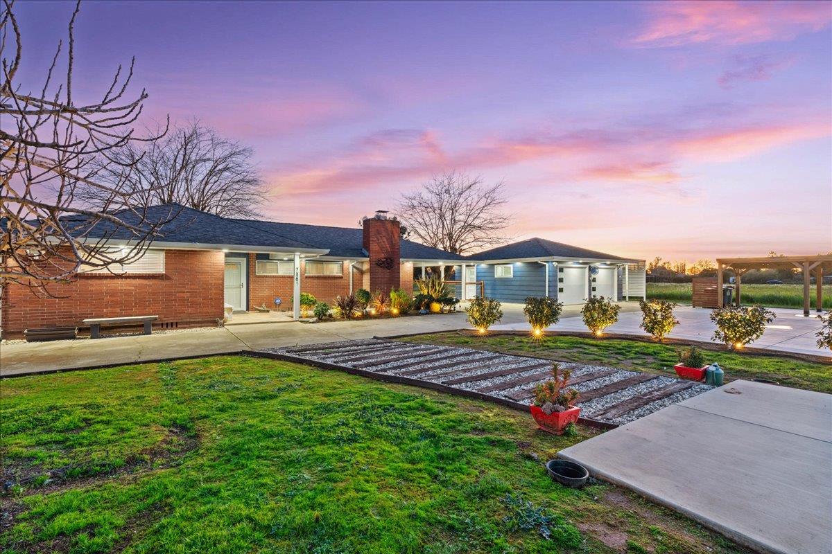 7261 Dry Creek Road Rio Linda, CA 95673 - Photo 38 of 60 a front view of a house with a yard table and chairs