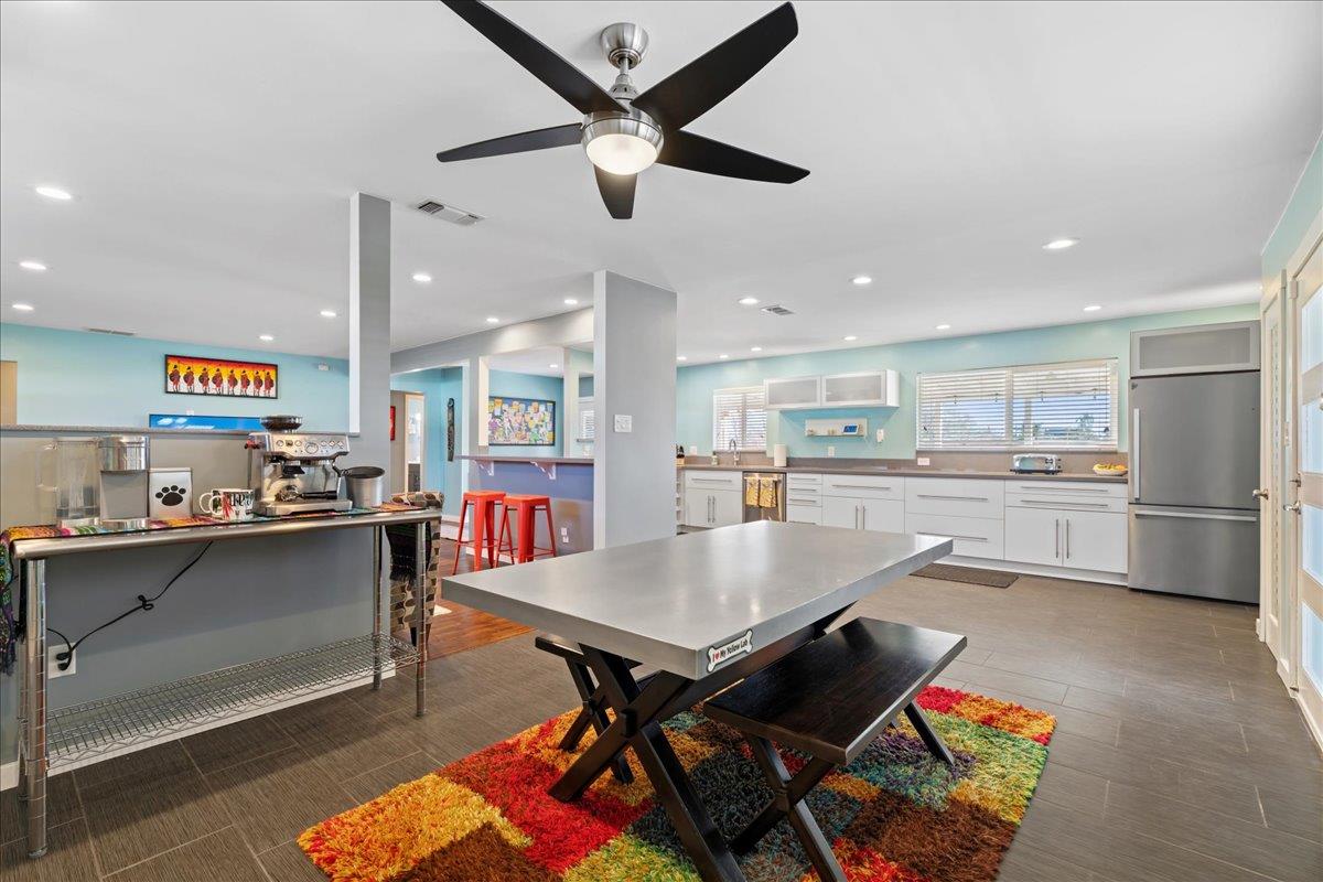 7261 Dry Creek Road Rio Linda, CA 95673 - Photo 5 of 60 a room with stainless steel appliances kitchen island granite countertop a dining table chairs and a refrigerator