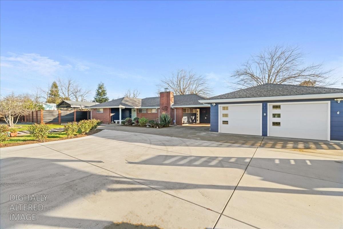 7261 Dry Creek Road Rio Linda, CA 95673 - Photo 54 of 59 a front view of a house with a yard and garage