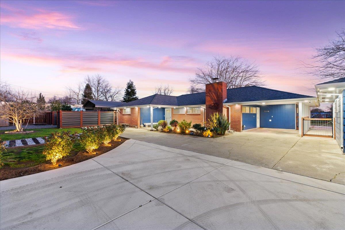 7261 Dry Creek Road Rio Linda, CA 95673 - Photo 57 of 59 a front view of a house with a yard and garage