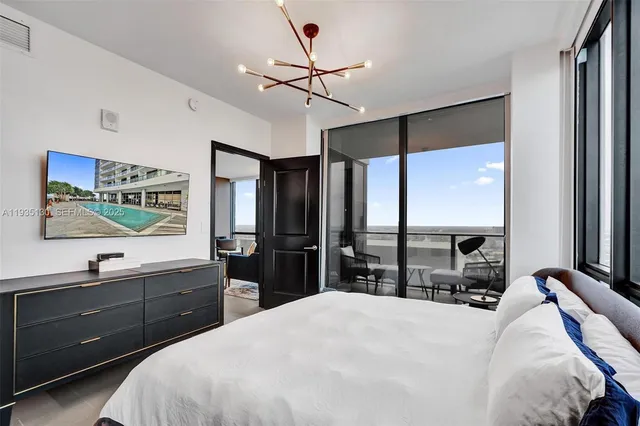 a bedroom with a large bed and a large window