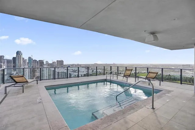 a view of a dining room with furniture and a chandelier