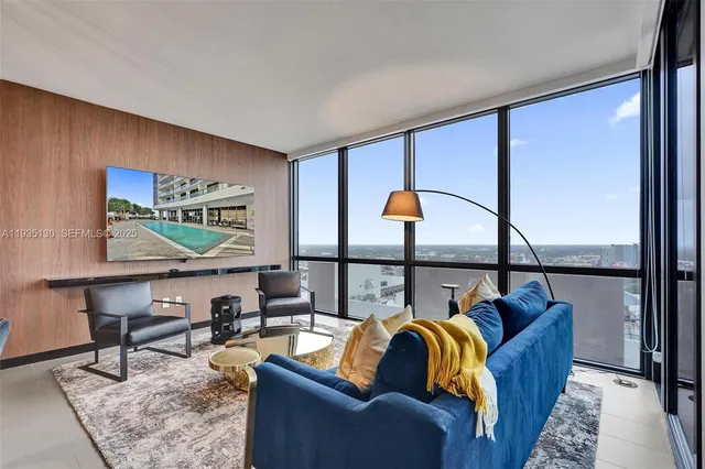a living room with furniture a rug and a window
