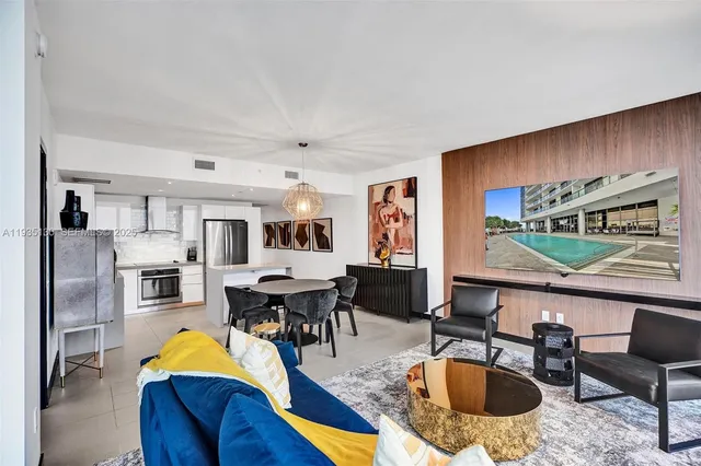 a living room with stainless steel appliances kitchen island granite countertop furniture and a kitchen view