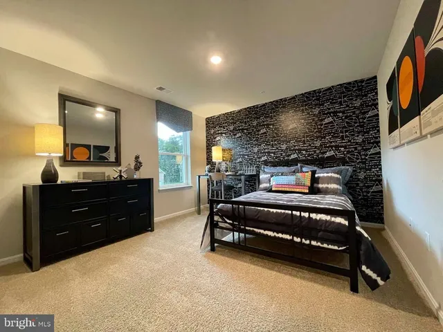 a bedroom with a bed and a mirror