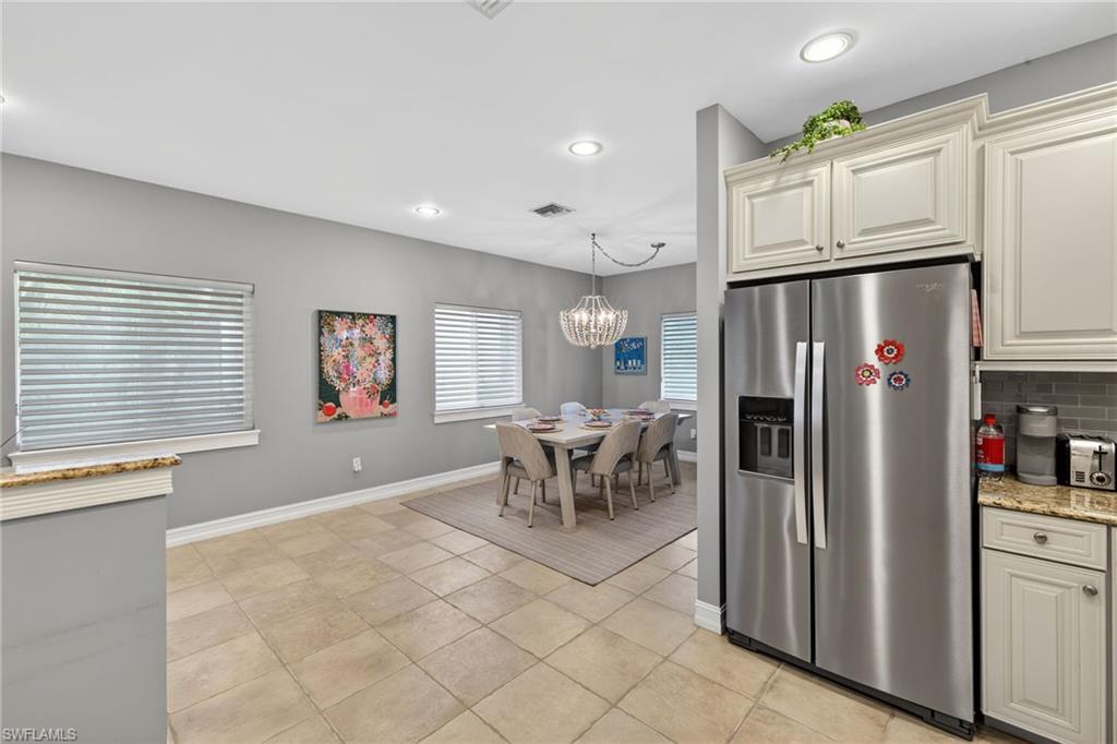 740 5th Avenue North Naples, FL 34102 - Photo 12 of 43 a kitchen with stainless steel appliances granite countertop a refrigerator and a stove top oven