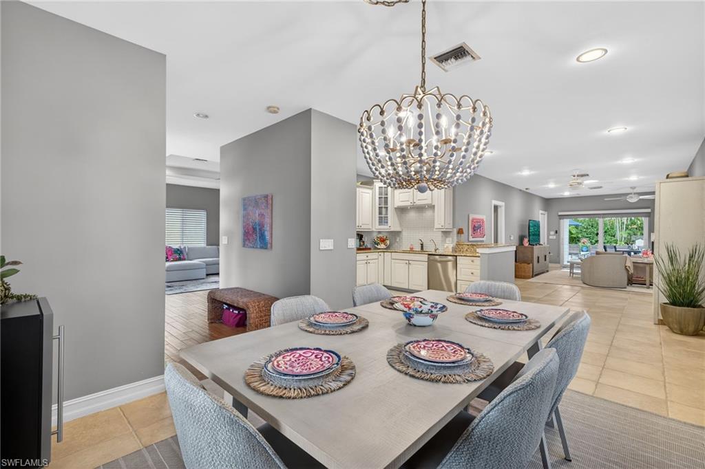 740 5th Avenue North Naples, FL 34102 - Photo 13 of 43 a view of a dining room with furniture and a chandelier