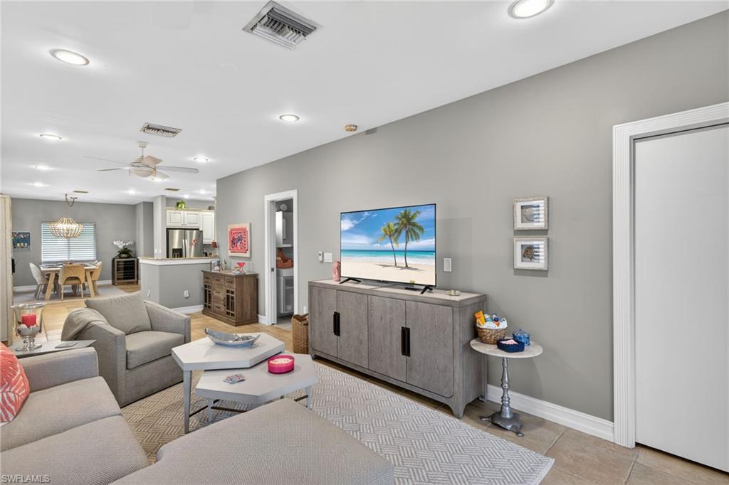 740 5th Avenue North Naples, FL 34102 - Photo 16 of 43 a living room with furniture and a table