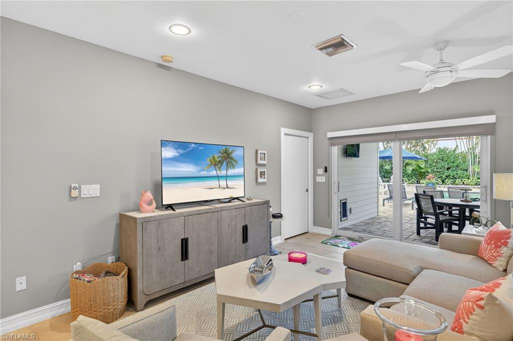 740 5th Avenue North Naples, FL 34102 - Photo 18 of 43 a living room with furniture and a large window
