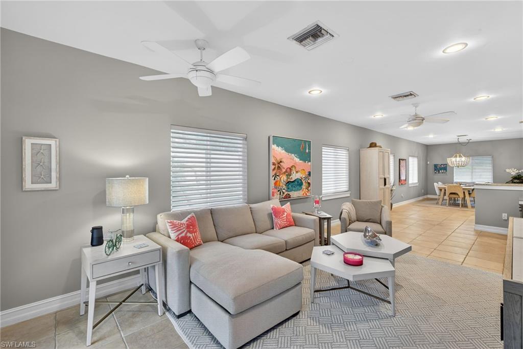 740 5th Avenue North Naples, FL 34102 - Photo 20 of 43 a living room with furniture and a chandelier