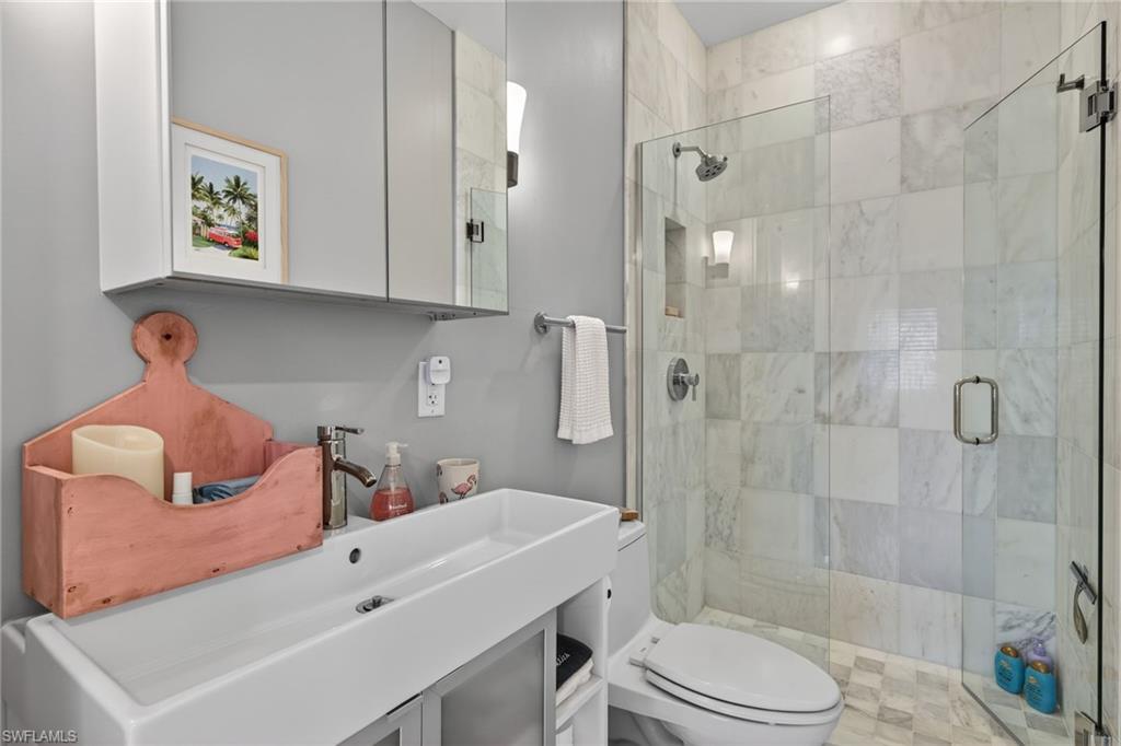 740 5th Avenue North Naples, FL 34102 - Photo 21 of 43 a bathroom with a sink toilet and shower