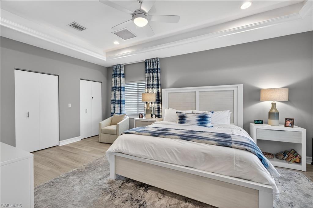 740 5th Avenue North Naples, FL 34102 - Photo 25 of 43 a bedroom with a bed and a lamp