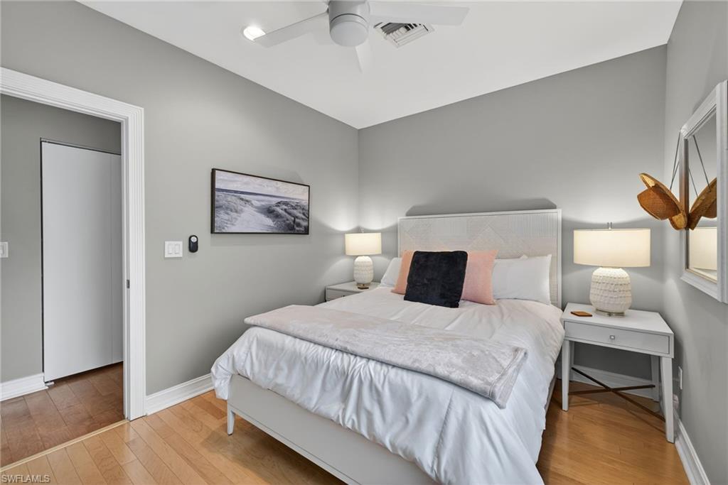 740 5th Avenue North Naples, FL 34102 - Photo 30 of 43 a bedroom with a bed and a night stand