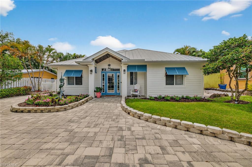740 5th Avenue North Naples, FL 34102 - Photo 3 of 43 a view of a house with a yard and potted plants