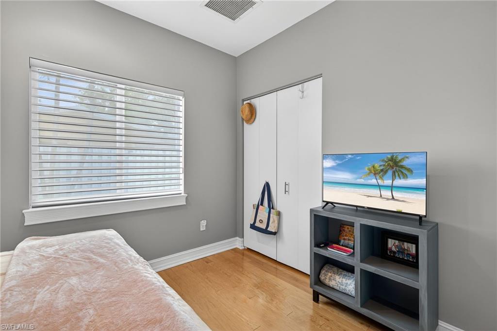 740 5th Avenue North Naples, FL 34102 - Photo 31 of 43 a bedroom with a bed and a window