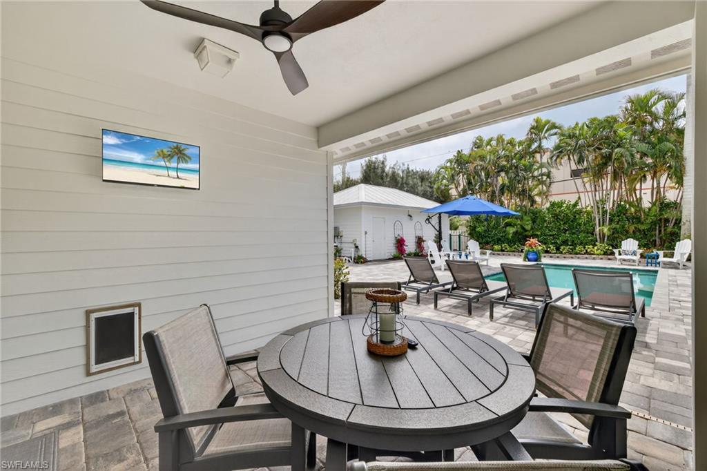 740 5th Avenue North Naples, FL 34102 - Photo 33 of 43 a table and chairs in front of a building