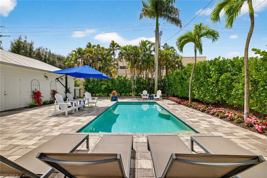 740 5th Avenue North Naples, FL 34102 - Photo 34 of 43 a view of a backyard with swimming pool and furniture