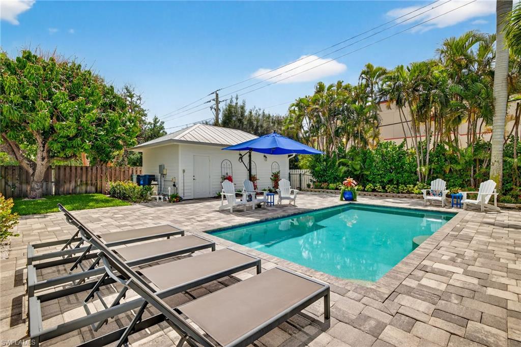 740 5th Avenue North Naples, FL 34102 - Photo 35 of 43 a view of a swimming pool with lounge chairs in patio