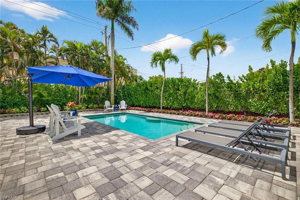 740 5th Avenue North Naples, FL 34102 - Photo 38 of 43 a view of a swimming pool with a patio