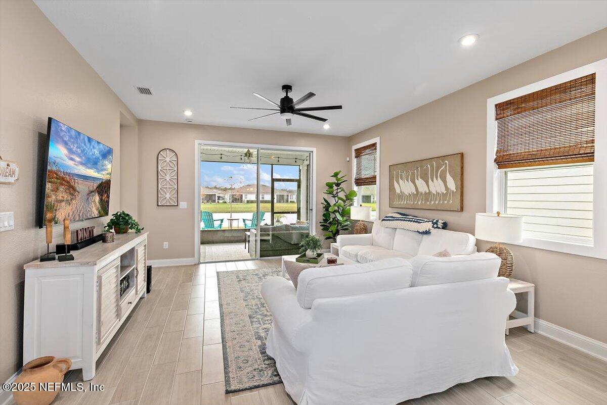 110 Fly Line Drive St. Johns, FL 32259 - Photo 11 of 65 a living room with furniture a large window and a flat screen tv