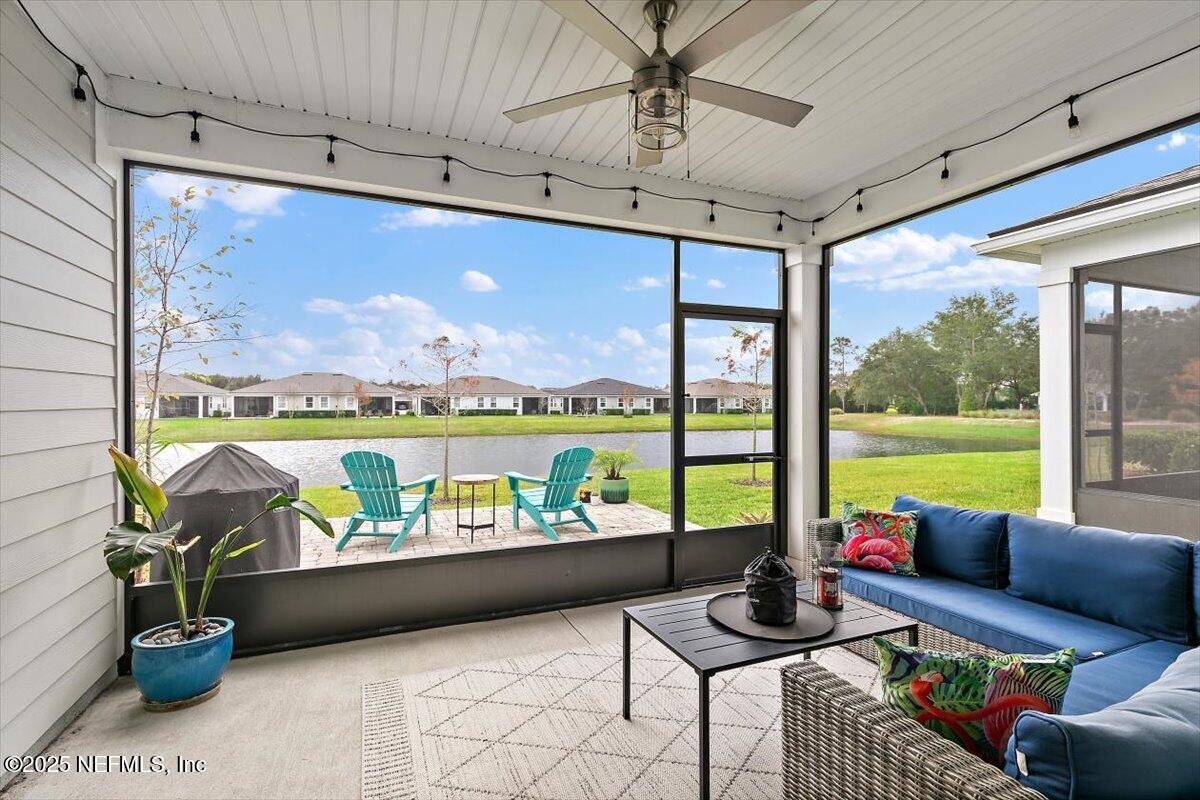 110 Fly Line Drive St. Johns, FL 32259 - Photo 12 of 65 a living room with furniture and a floor to ceiling window
