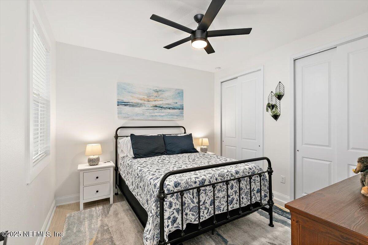 110 Fly Line Drive St. Johns, FL 32259 - Photo 18 of 65 a bedroom with a bed and a chandelier