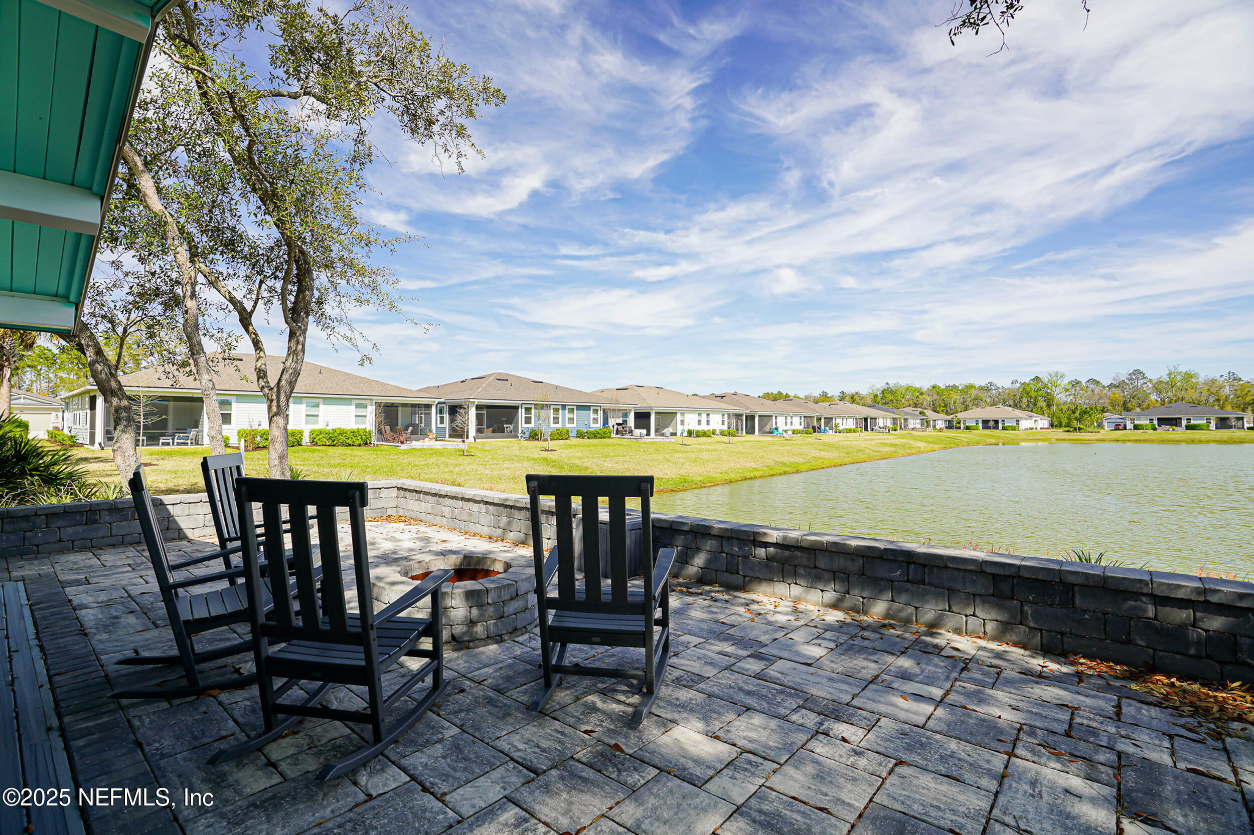 110 Fly Line Drive St. Johns, FL 32259 - Photo 43 of 65 a view of a swimming pool with outdoor seating and lake