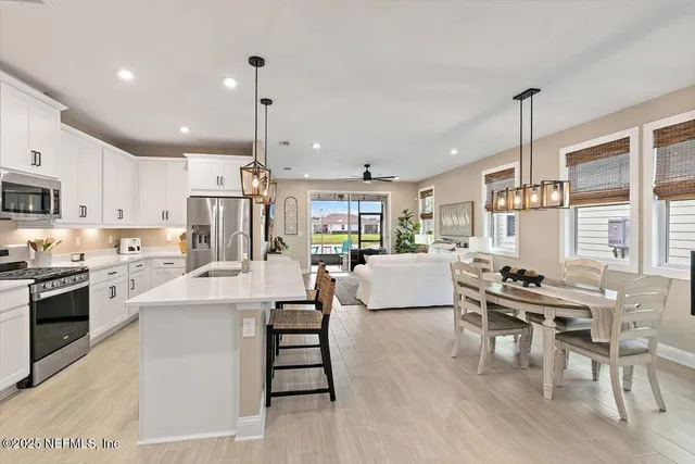 a view of a hallway with wooden floor and workspace