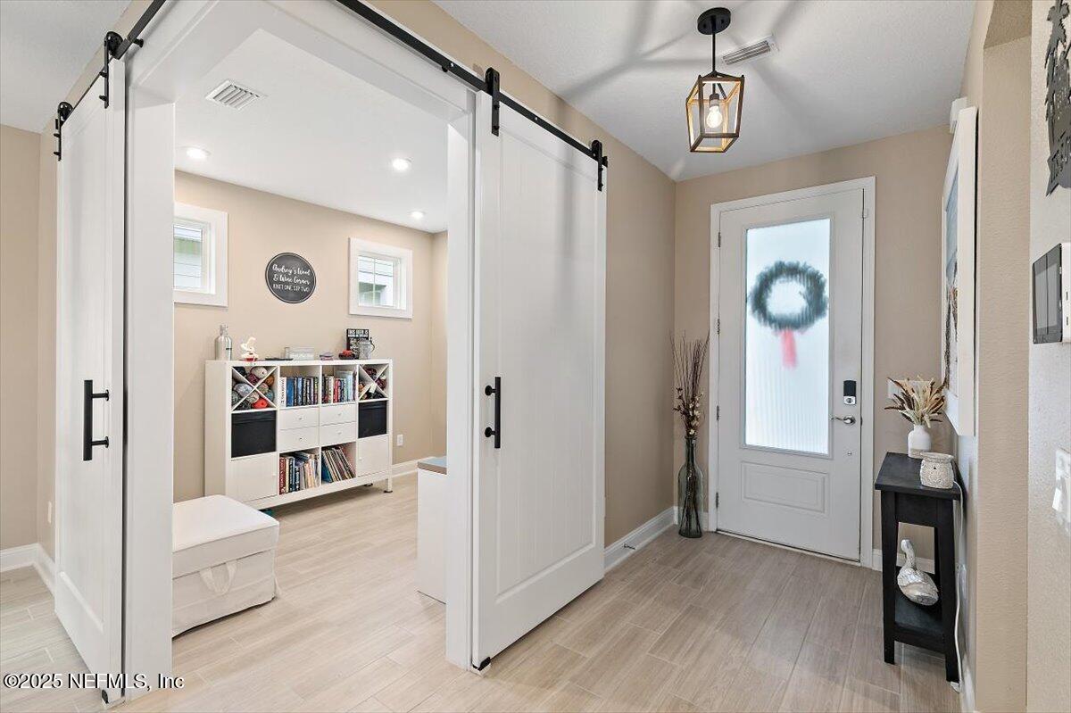 110 Fly Line Drive St. Johns, FL 32259 - Photo 6 of 65 a view of a hallway with wooden floor and workspace