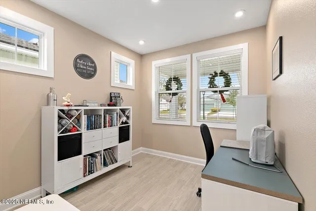 a kitchen with refrigerator a sink and chairs