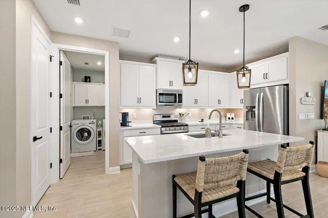 a kitchen with stainless steel appliances a refrigerator sink and cabinets