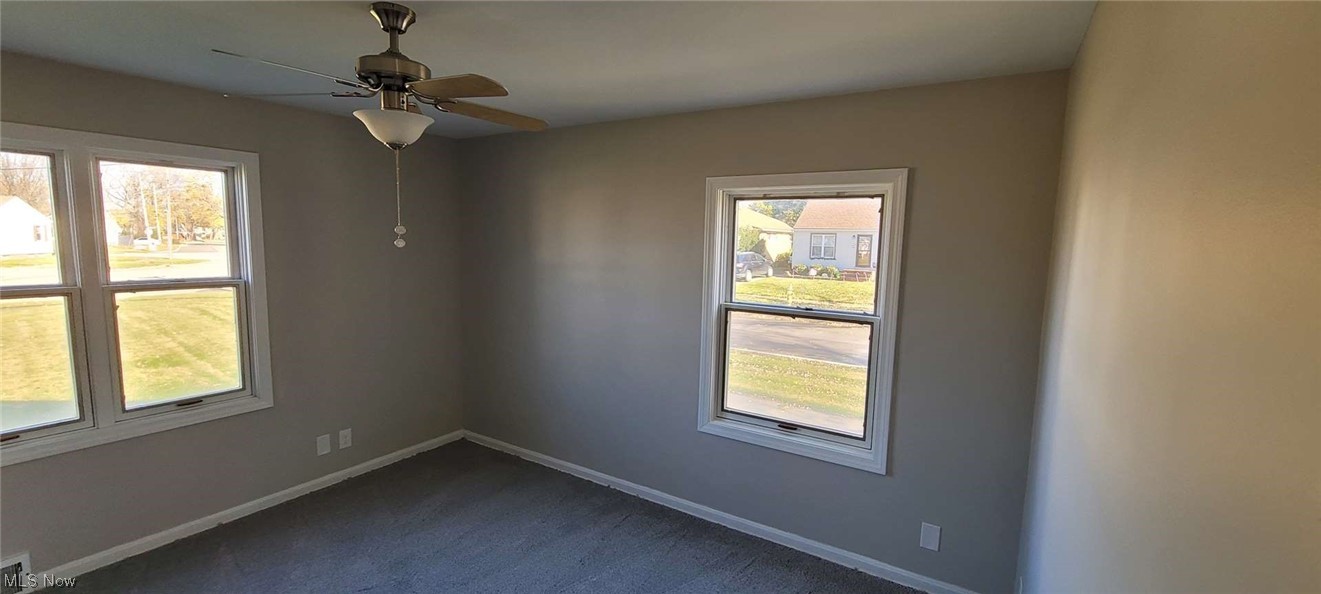 6149 North Canterbury Road Parma, OH 44129 - Photo 8 of 16 Carpeted empty room with ceiling fan and plenty of natural light