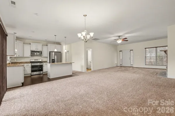 a view of a kitchen with a sink and stainless steel appliances