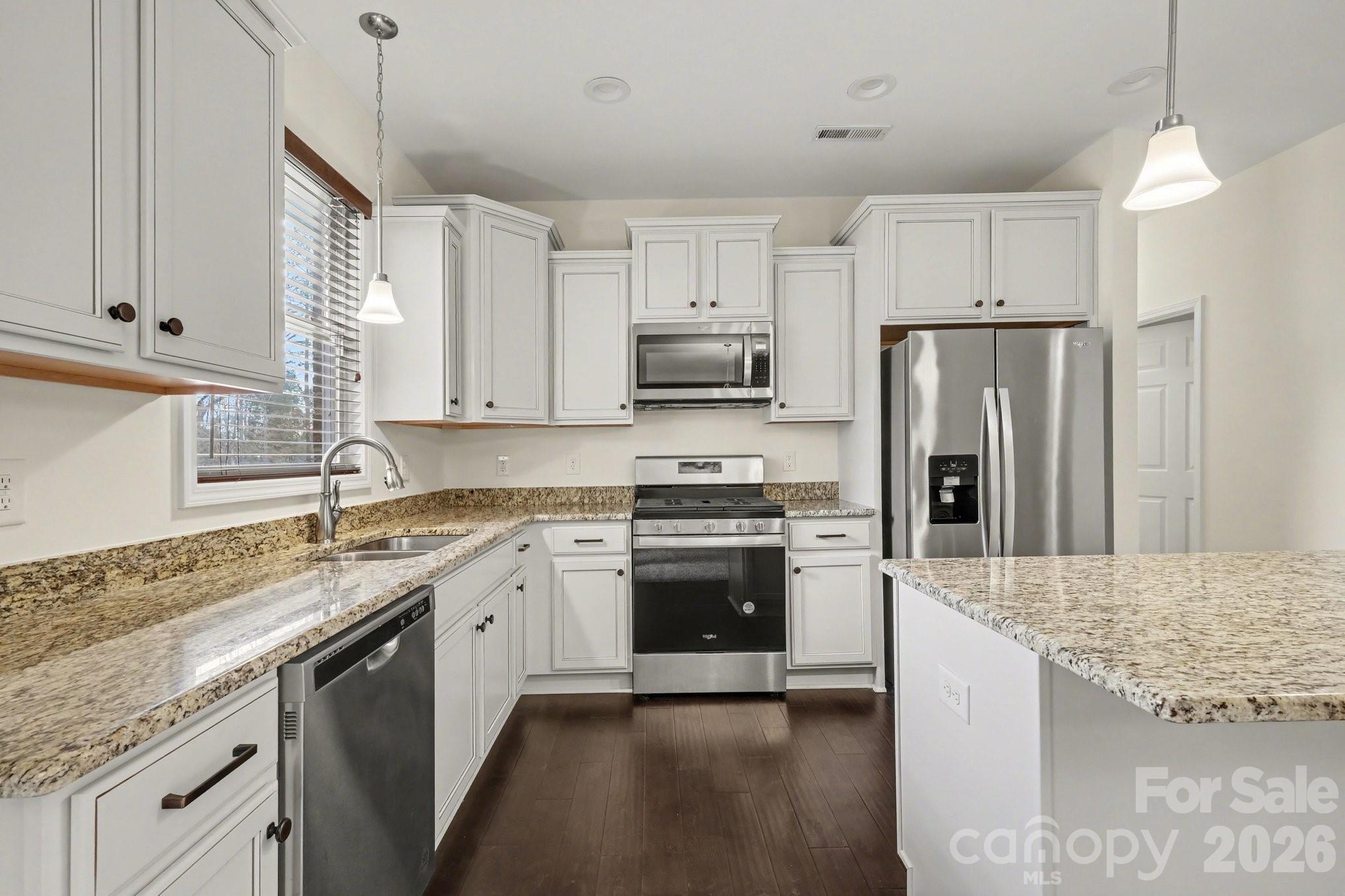 175 Cox Lake Road Stanley, NC 28164 - Photo 17 of 45 a kitchen with stainless steel appliances granite countertop a sink stove and refrigerator