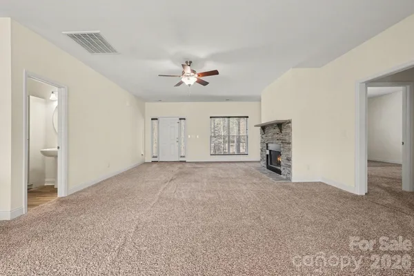 a view of empty room with ceiling fan