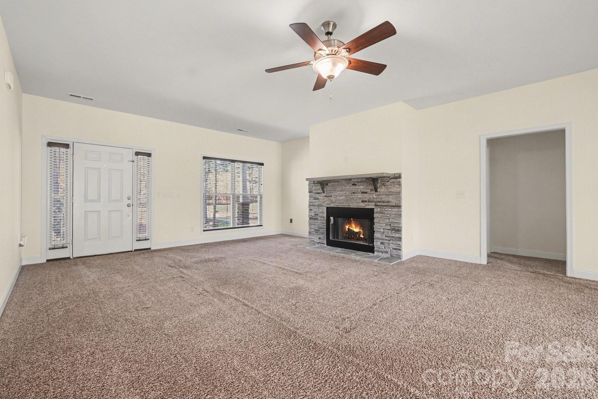 175 Cox Lake Road Stanley, NC 28164 - Photo 21 of 45 a view of an empty room with chandelier fan and fire place