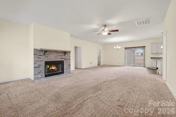 a view of empty room with a fireplace