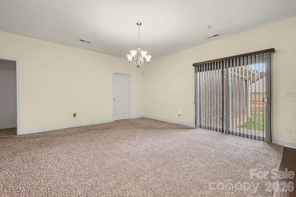 a view of a chandelier in big room and chandelier fan