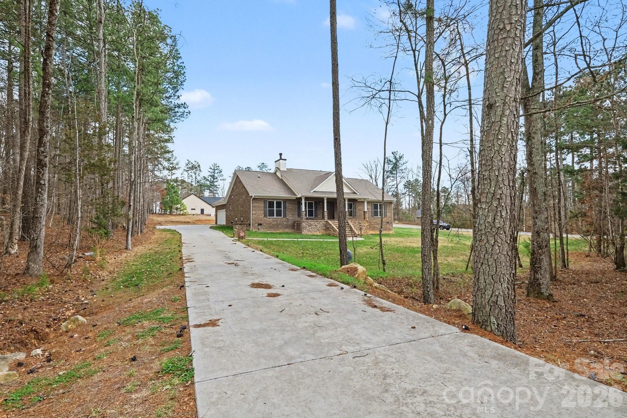 175 Cox Lake Road Stanley, NC 28164 - Photo 37 of 45 a view of a street and trees on both side of it