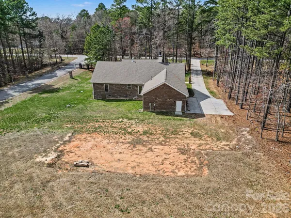 a view of a house with a yard and sitting area