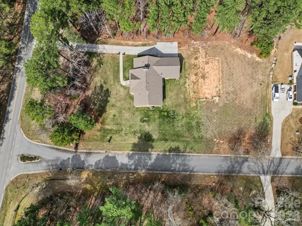 an aerial view of a house with a yard