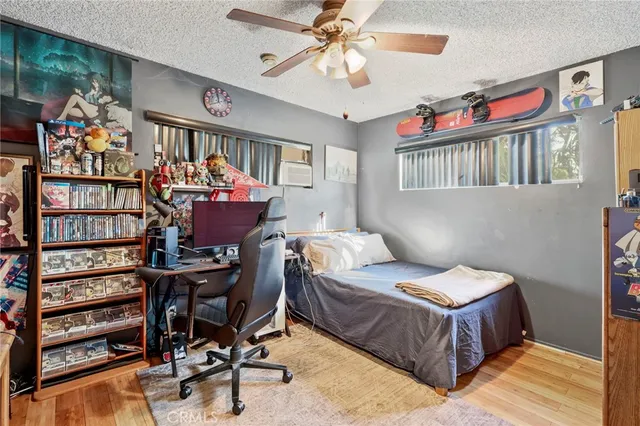 a bedroom with furniture and a flat screen tv